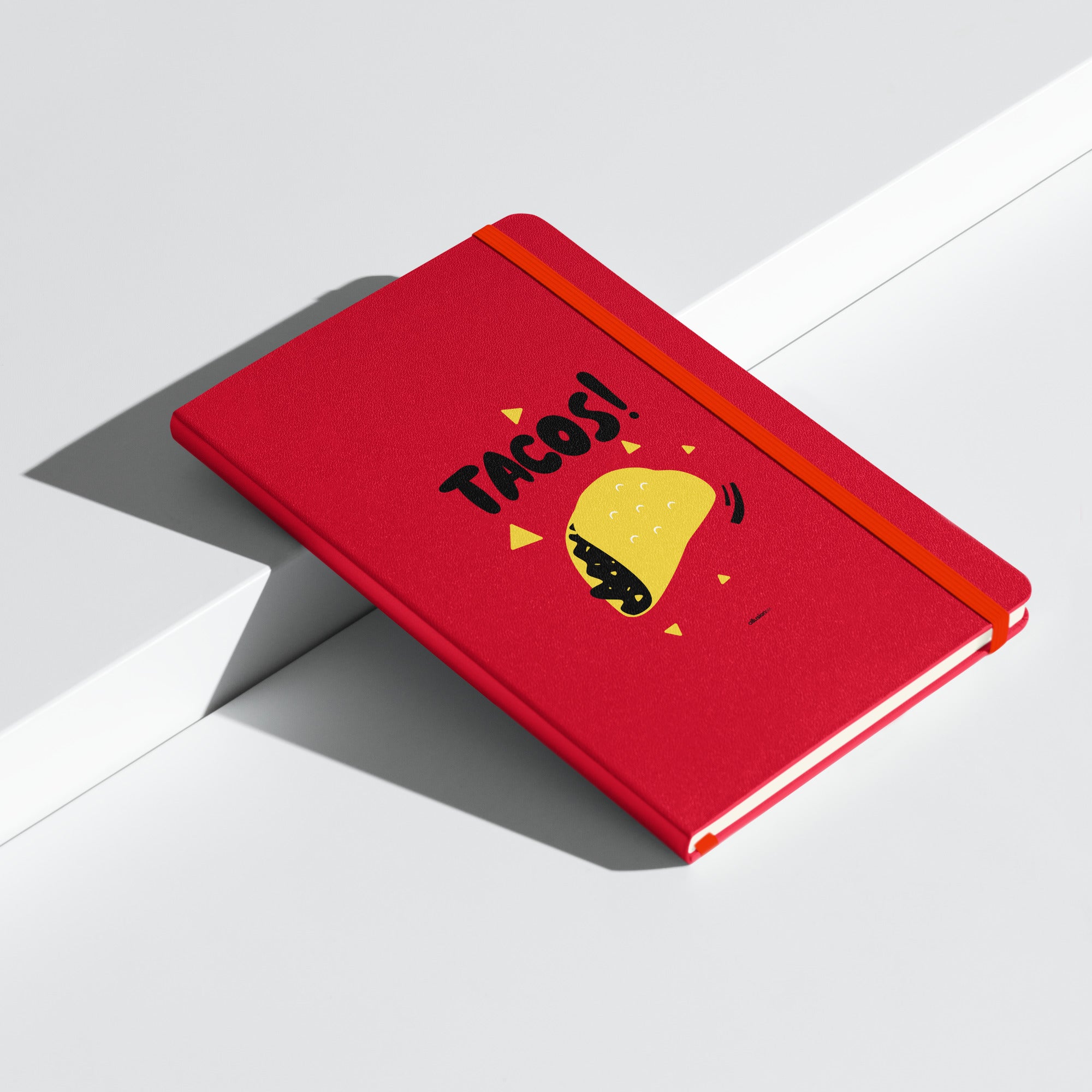 Red hardcover UltraHyde notebook featuring a bold "TACOS!" design with a yellow taco illustration and black accents.