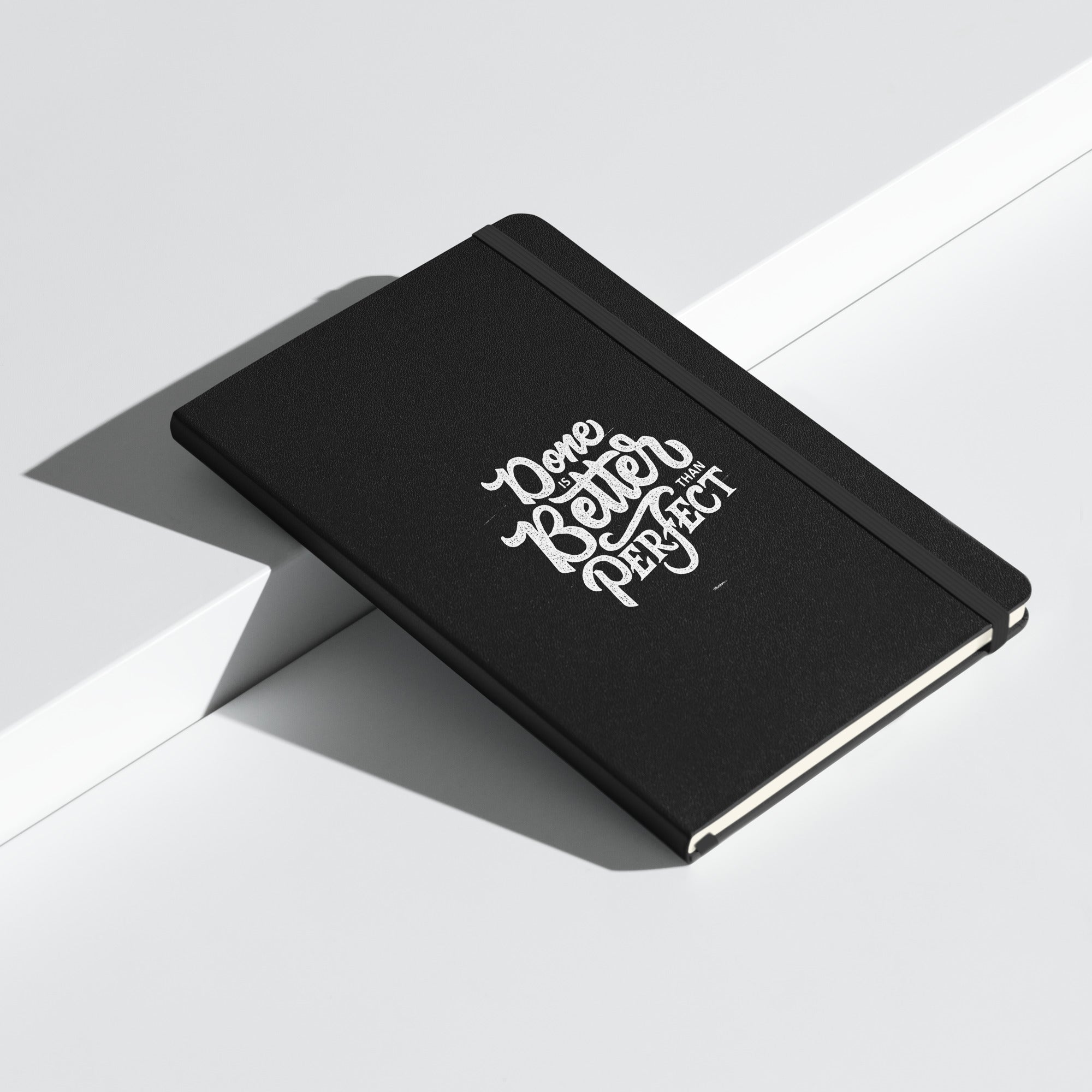 Black hardcover notebook with motivational quote 'Done is Better Than Perfect' in white text, elastic closure displayed.