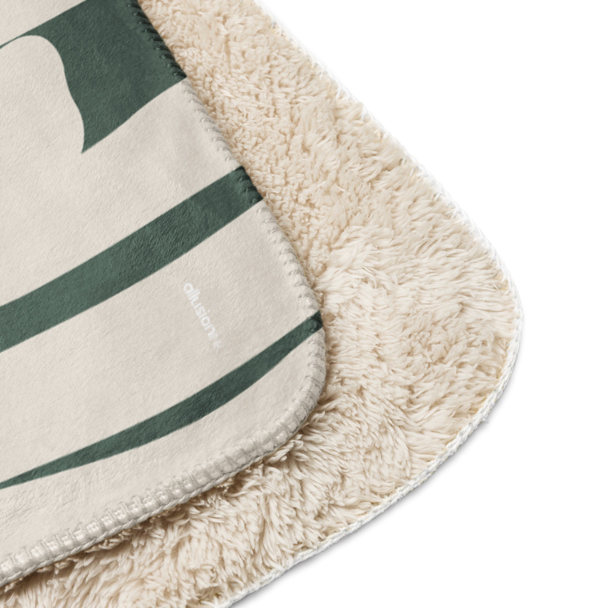 Close-up of green botanical sherpa blanket showing the ultra-soft fleece lining and smooth printed design.