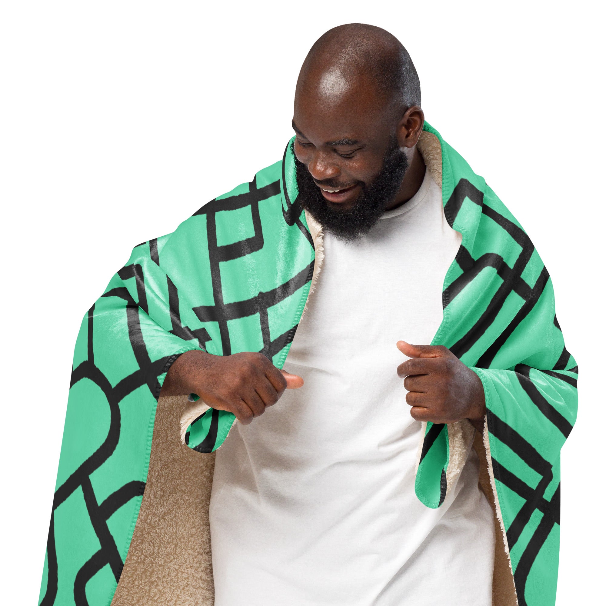 A man wrapped in a cozy sherpa blanket with a modern geometric design, enjoying its soft and warm comfort.