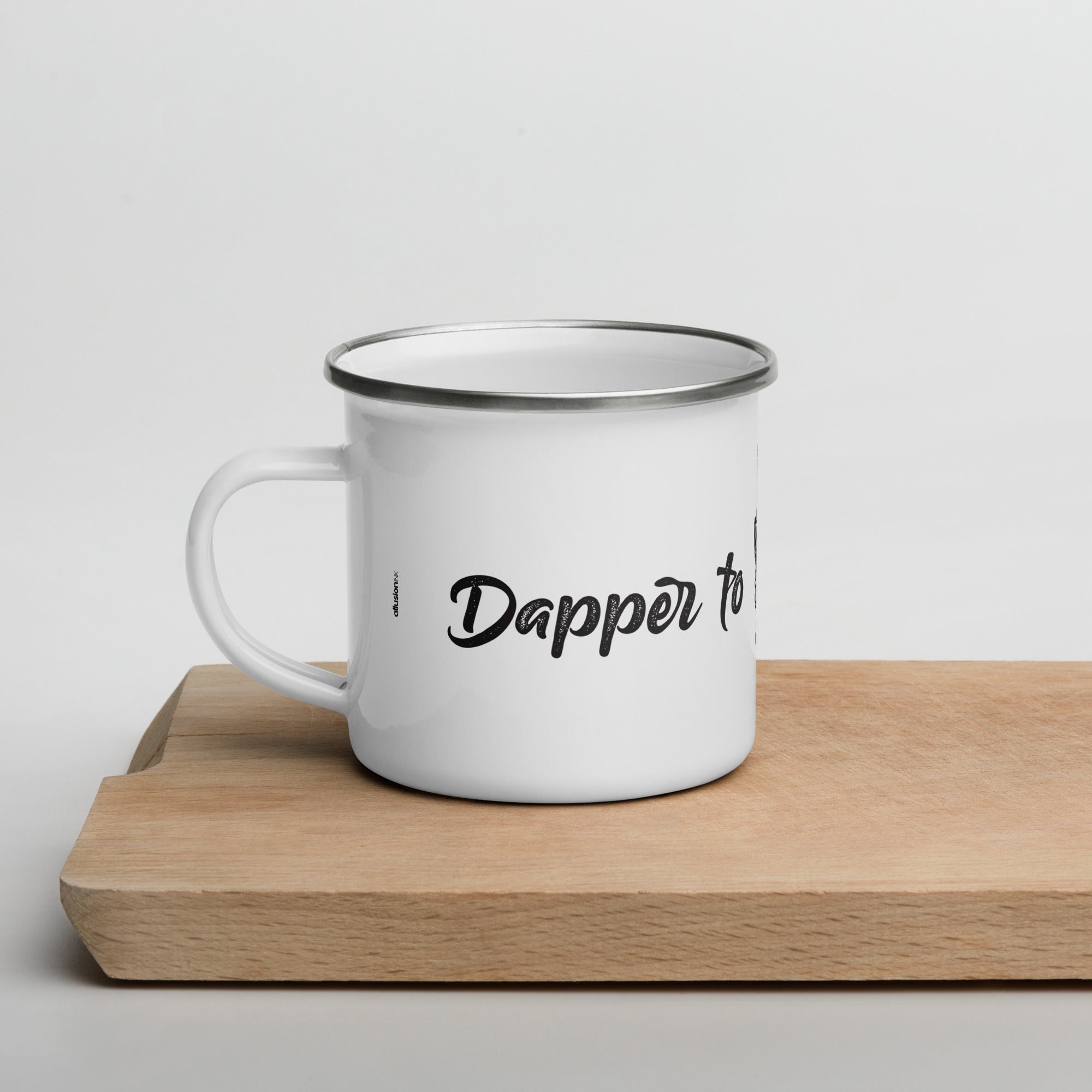 Left side view of the "Dapper to the Grave" enamel mug showing elegant text design.