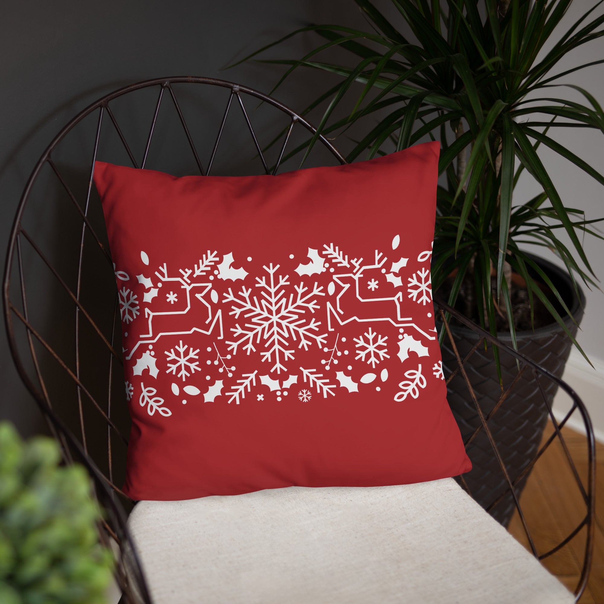 Reindeer holiday pillow styled on a modern armchair, perfect for seasonal home decor.