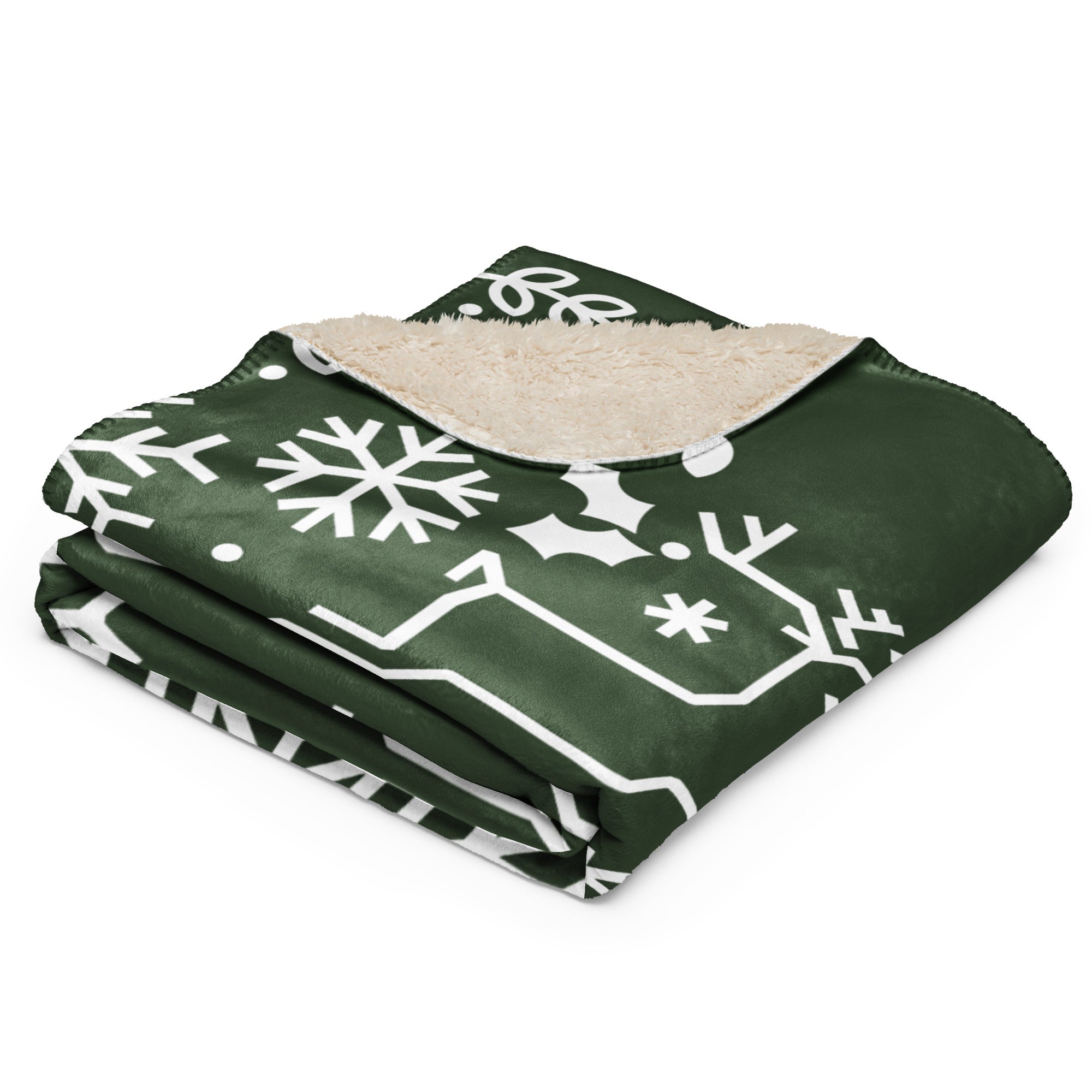 Close-up of the folded Forest Green Sherpa Blanket with festive snowflake and holly design.