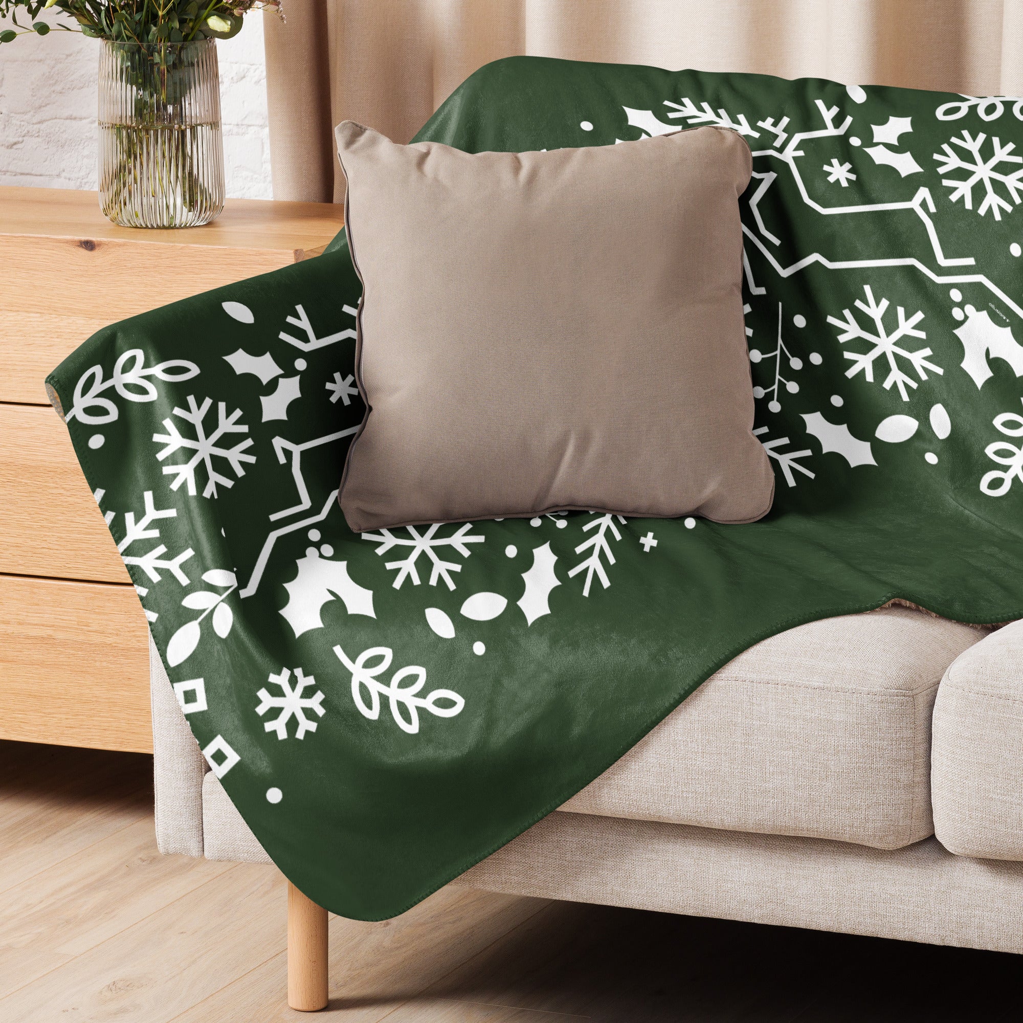 Forest Green Sherpa Blanket draped over a sofa, highlighting the smooth patterned fabric and soft sherpa underside.