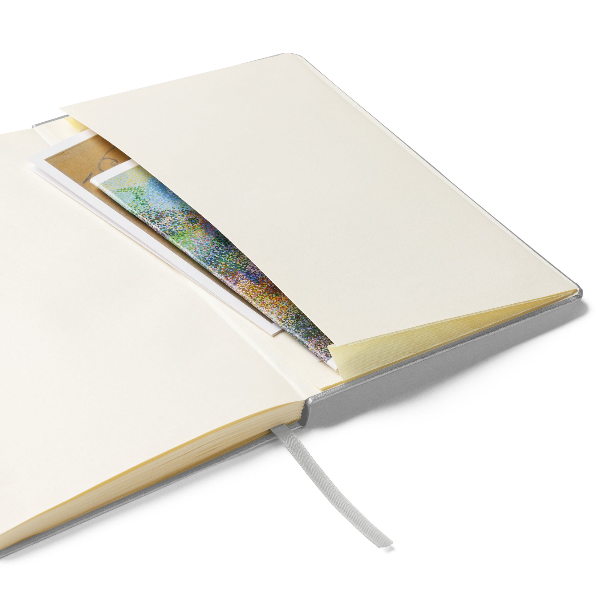 Silver hardcover notebook showing expandable inner pocket for notes and matching silver ribbon marker.