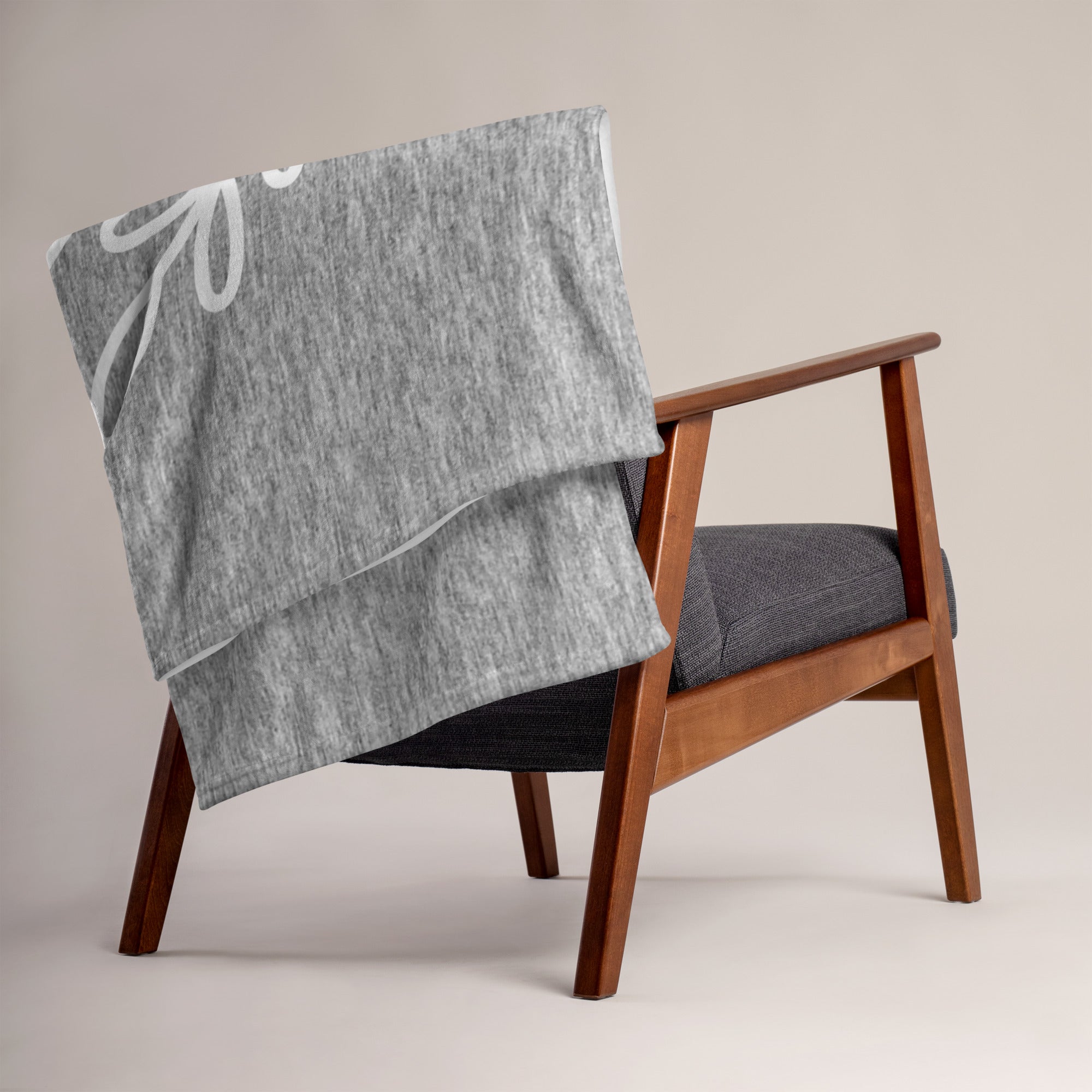 Gray Heather Leaf Throw Blanket draped over a wooden chair for cozy décor.