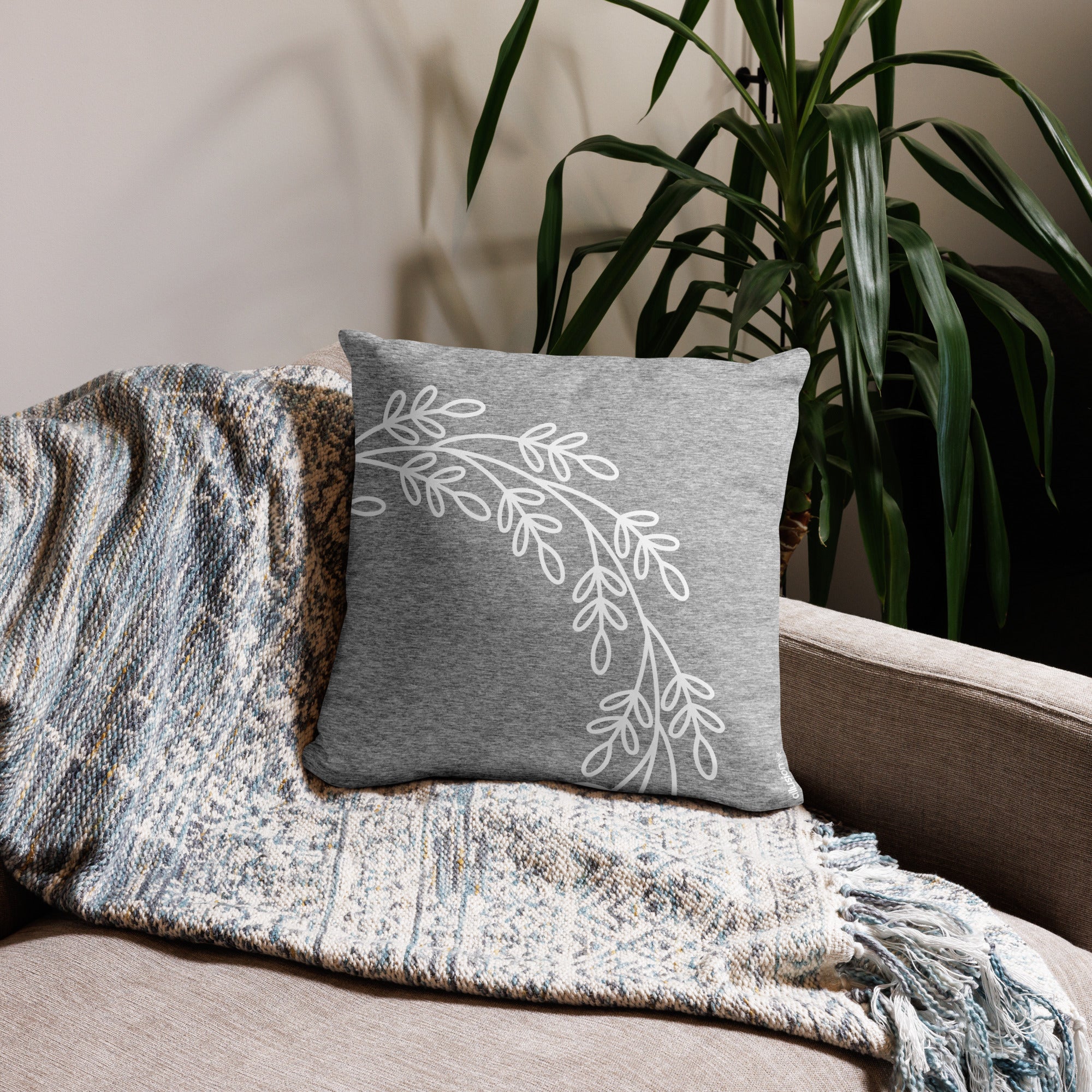 Back view of the gray decorative pillow with a white wreath design, showcasing a minimalist style.