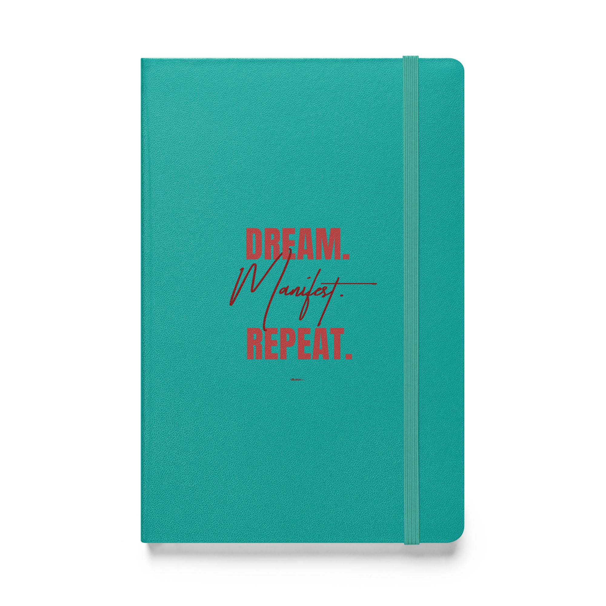 Turquoise hardcover notebook with 'Dream. Manifest. Repeat.' in stylish red font, combining elegance and motivation.