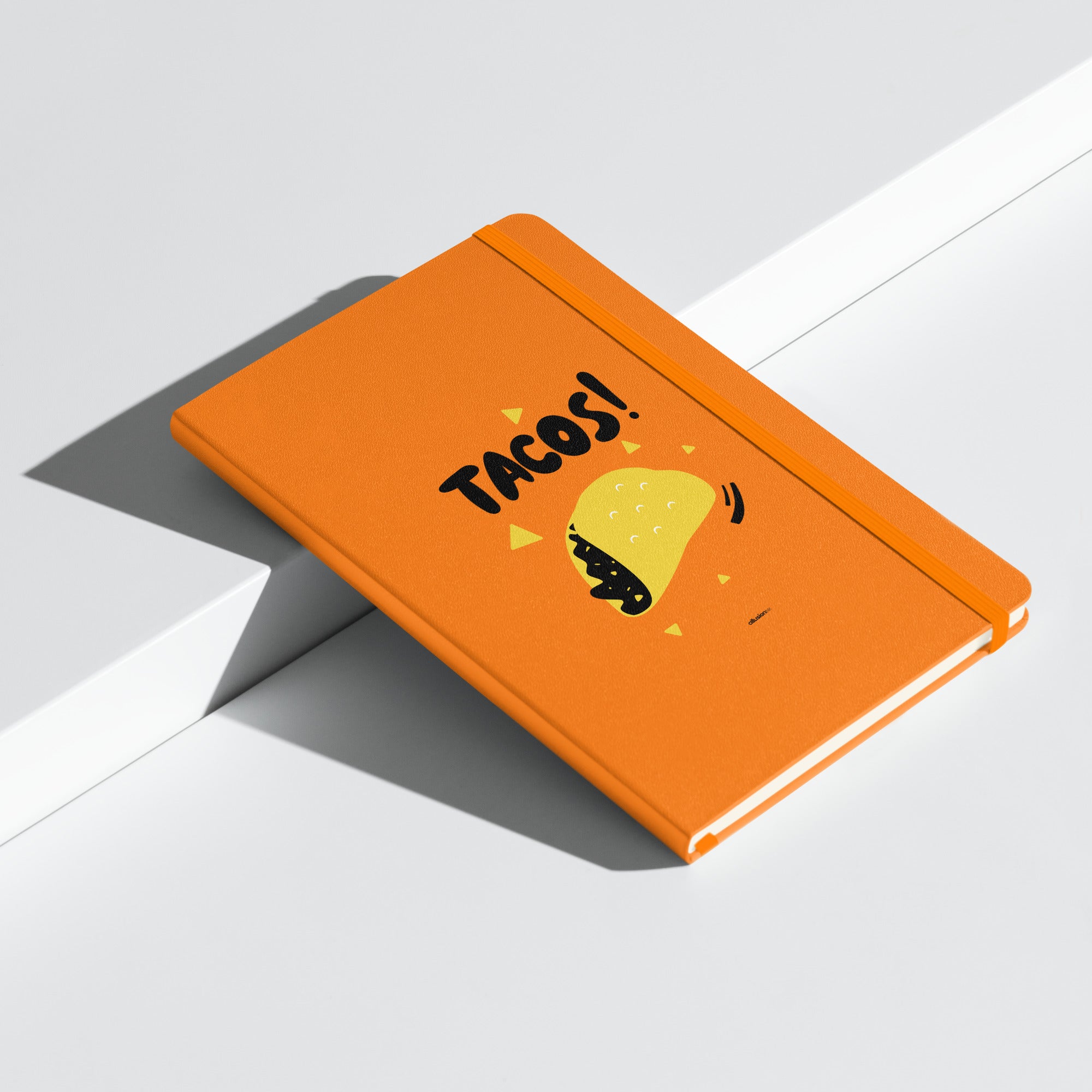 Orange hardcover UltraHyde notebook with bold "TACOS!" design and a yellow taco illustration on the cover.