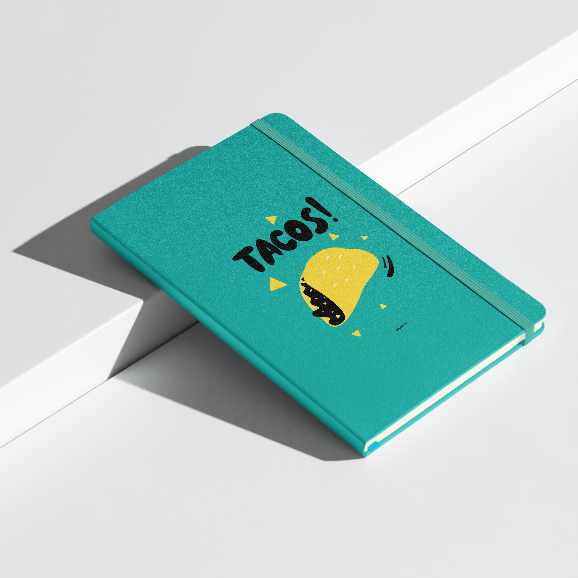 Turquoise UltraHyde notebook shown at an angle, featuring a matching elastic closure and ribbon marker.