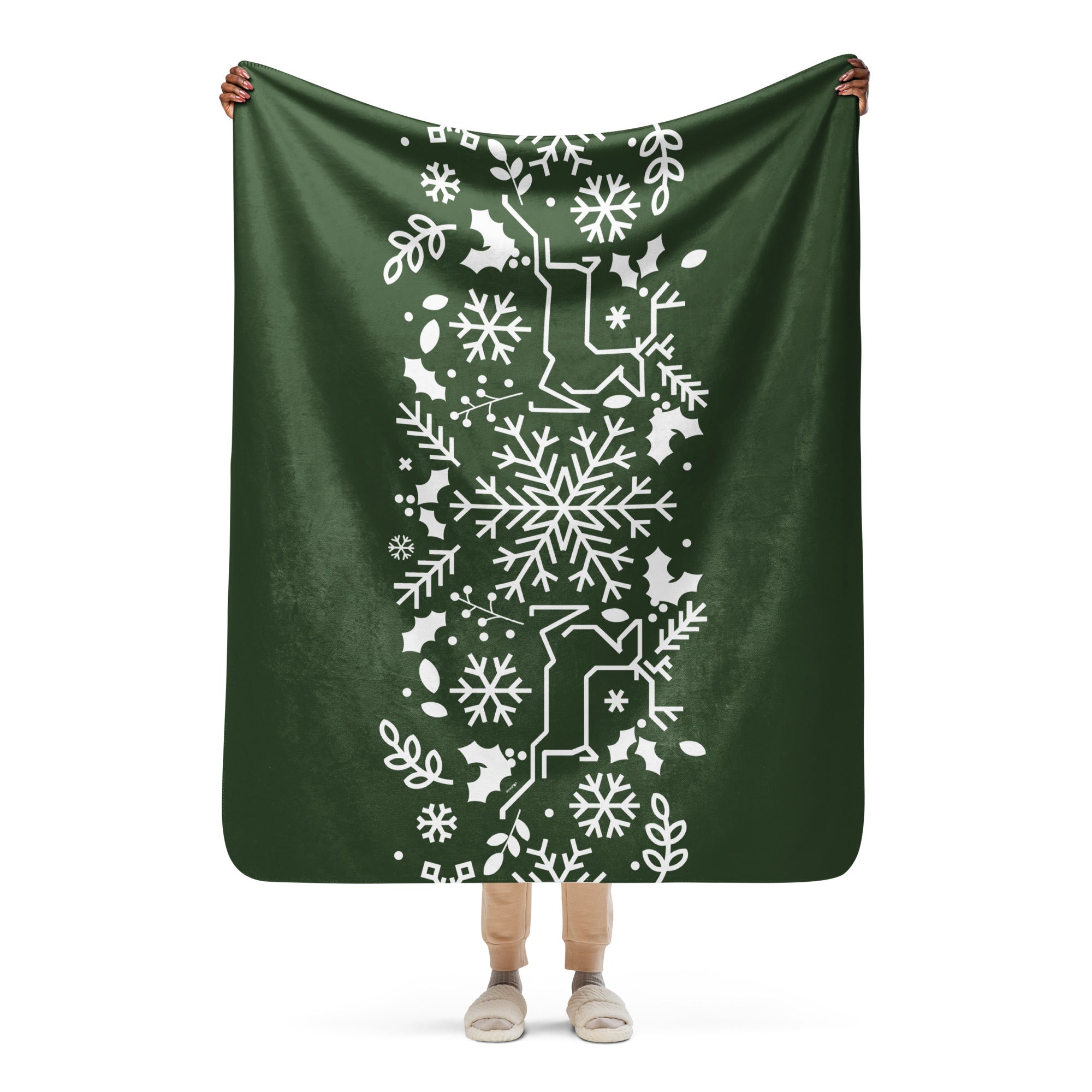 Holiday-inspired Forest Green Sherpa Blanket spread out, showcasing its snowflake and holly design in full detail.