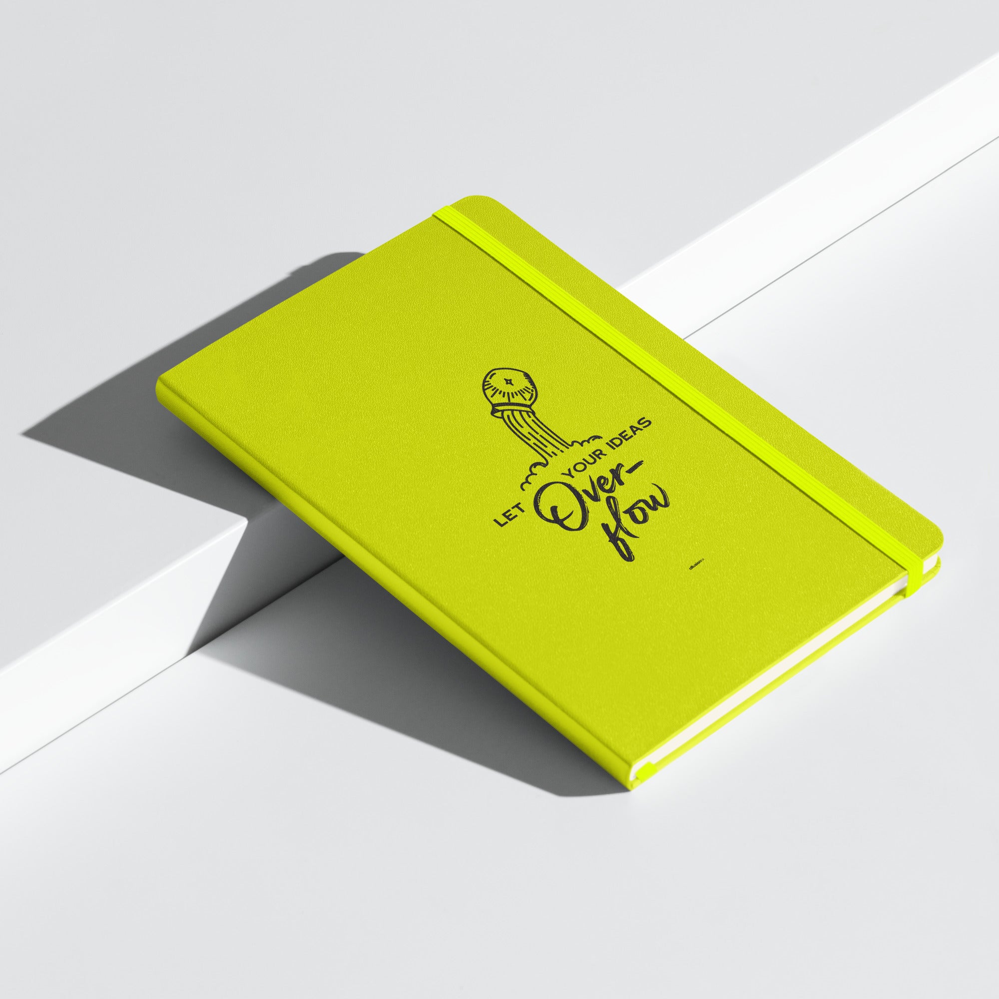 Lime green hardcover notebook with 'Let Your Ideas Overflow' design, displayed at an angle.