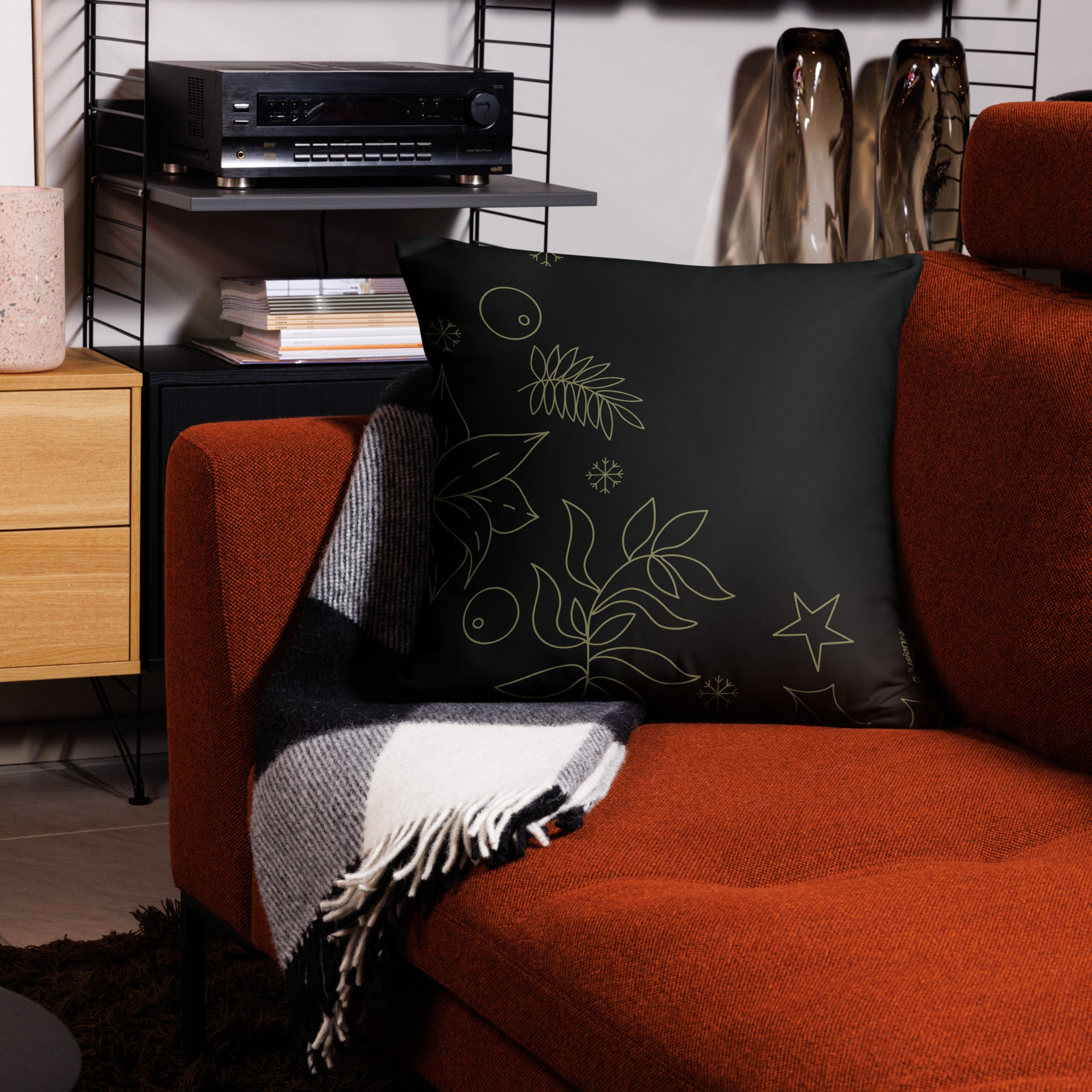 Back view of a larger Christmas pillow showcasing gold botanical accents on a sleek black backdrop, ideal for cozy holiday spaces.