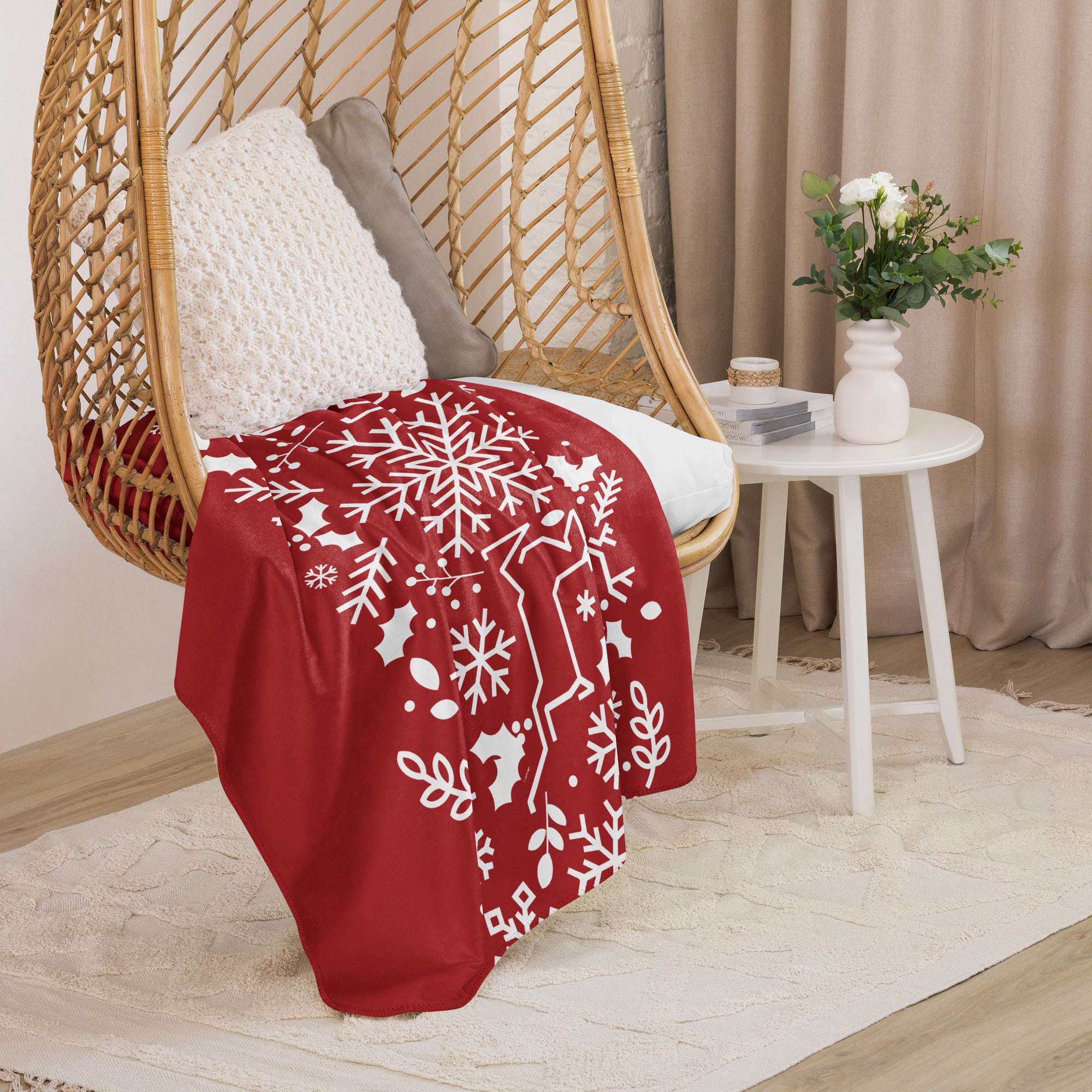 Holiday-themed red sherpa blanket draped over a chair in a cozy living room setting.