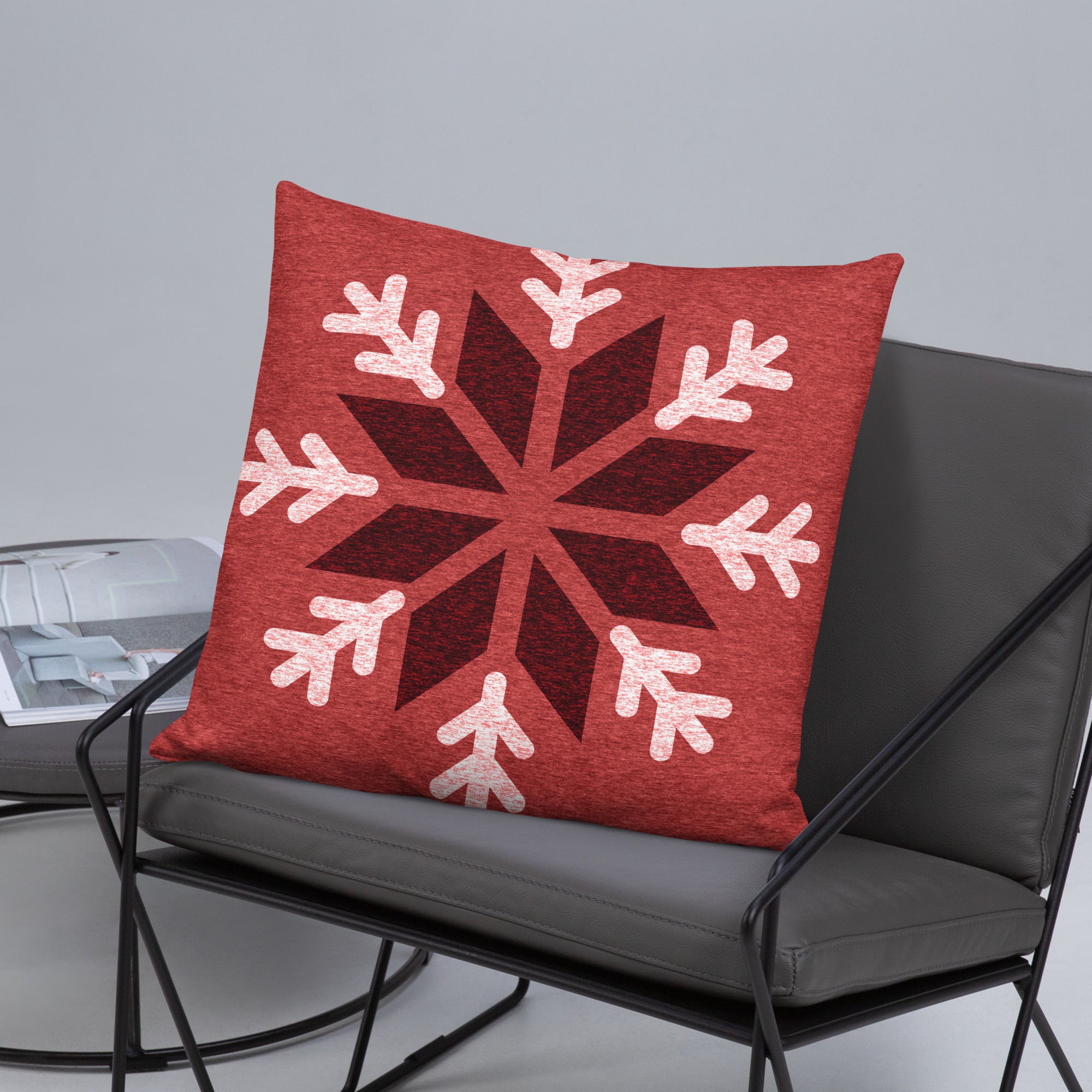 Red 22x22 snowflake pillow displayed on a chair for a festive and warm touch.