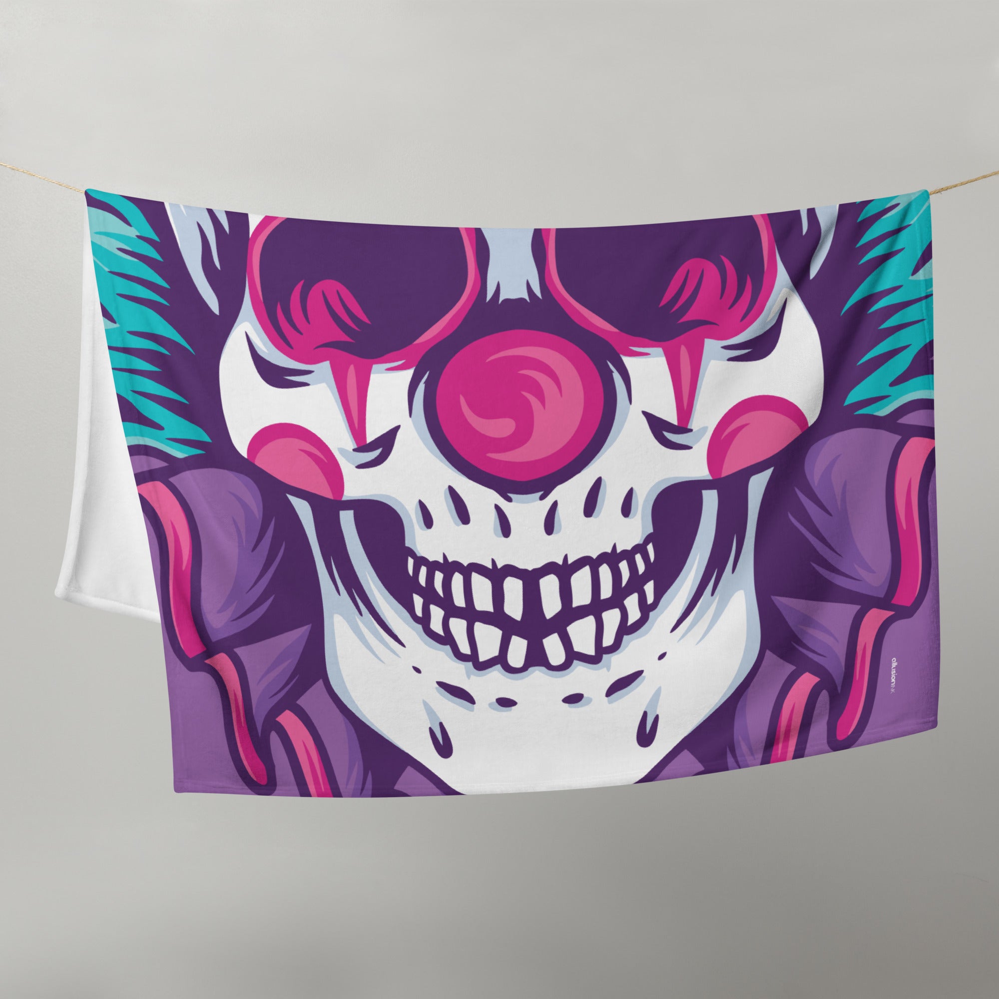 Vibrant Clown Skull Throw Blanket hanging, showcasing its bold design and vivid colors.